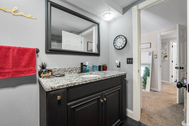 bathroom with vanity and baseboards