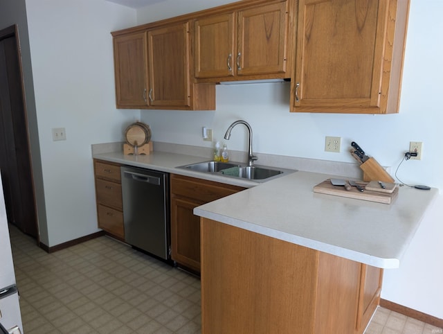 kitchen featuring a sink, light countertops, dishwasher, light floors, and brown cabinetry