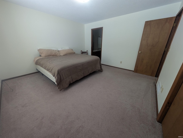 bedroom with light carpet, connected bathroom, and baseboards