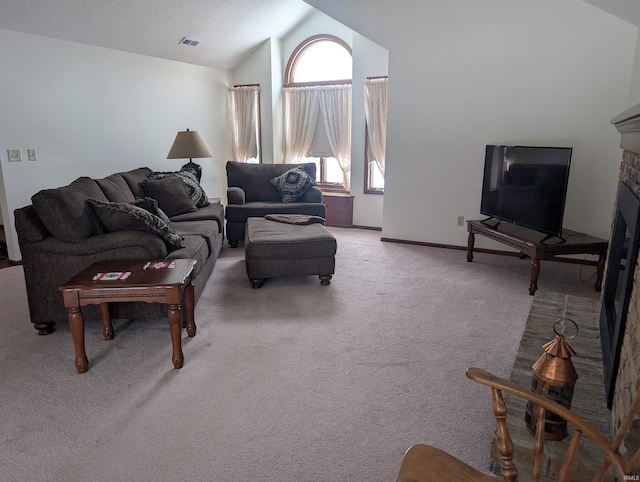 carpeted living room featuring lofted ceiling, visible vents, a fireplace, and baseboards