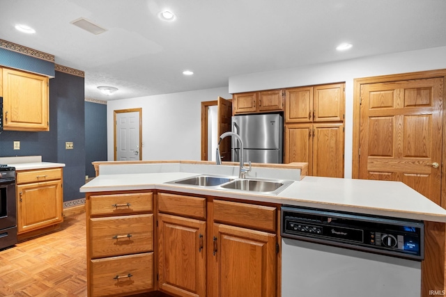 kitchen featuring light countertops, freestanding refrigerator, a sink, an island with sink, and dishwasher