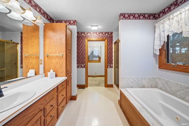 bathroom with vanity, baseboards, a whirlpool tub, a stall shower, and wallpapered walls