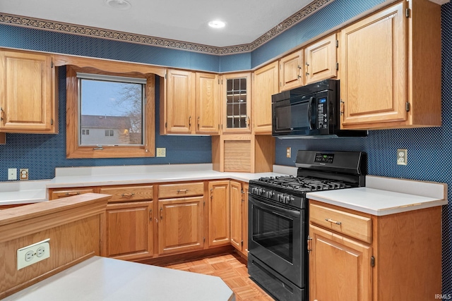 kitchen with recessed lighting, light countertops, and black appliances