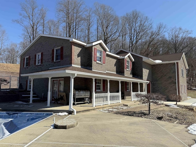 view of front facade featuring a porch and brick siding