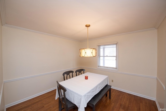 dining area with dark wood-style floors, baseboards, and ornamental molding