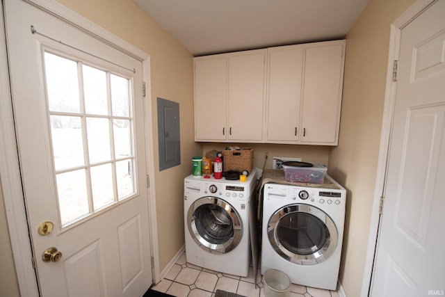 clothes washing area with cabinet space, electric panel, baseboards, and washer and dryer