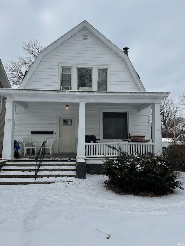 dutch colonial featuring a porch and a gambrel roof