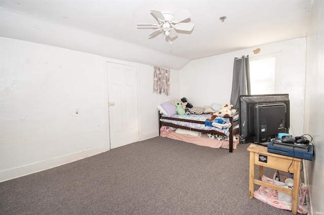 carpeted bedroom featuring lofted ceiling, baseboards, and a ceiling fan