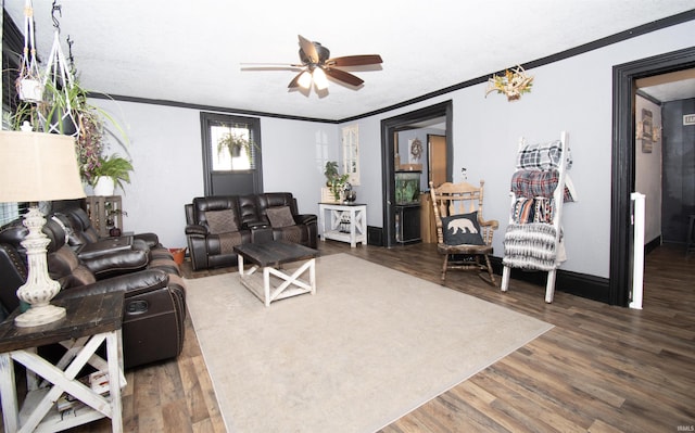 living area with ceiling fan, dark wood-style flooring, baseboards, and crown molding