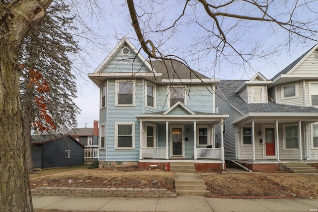 victorian-style house with covered porch and roof with shingles