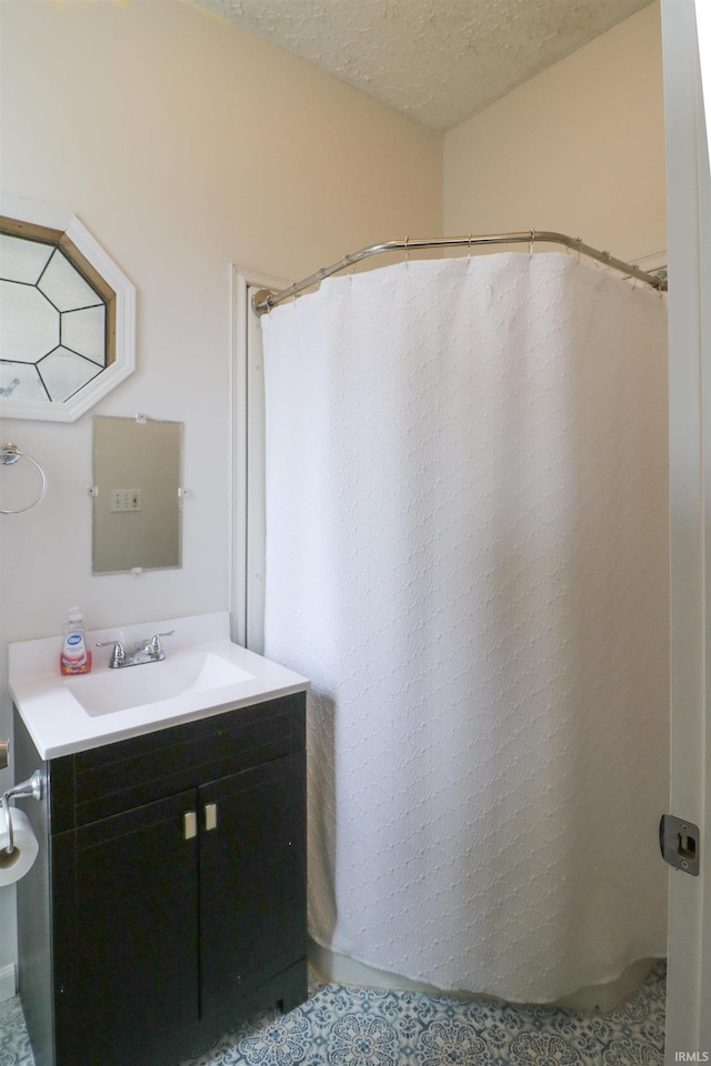 bathroom with a textured ceiling and vanity