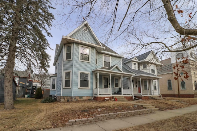 victorian-style house featuring a porch and crawl space