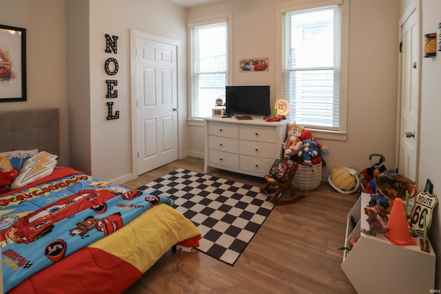 bedroom featuring wood finished floors and baseboards