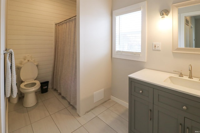 bathroom with vanity, curtained shower, tile patterned flooring, and toilet