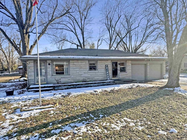 view of front of home with a garage, stone siding, and driveway