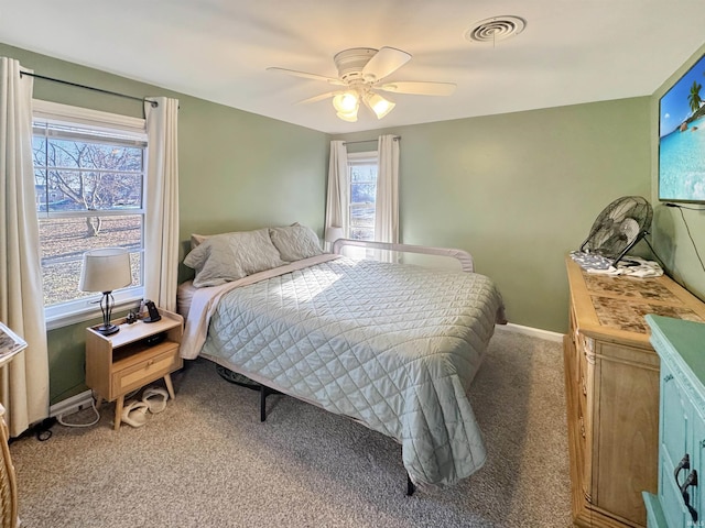 bedroom with visible vents, baseboards, a ceiling fan, and carpet floors