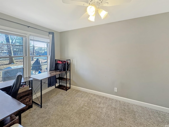 office space with a ceiling fan, baseboards, and carpet floors