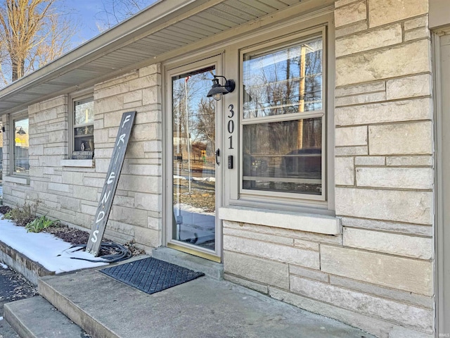 doorway to property featuring stone siding