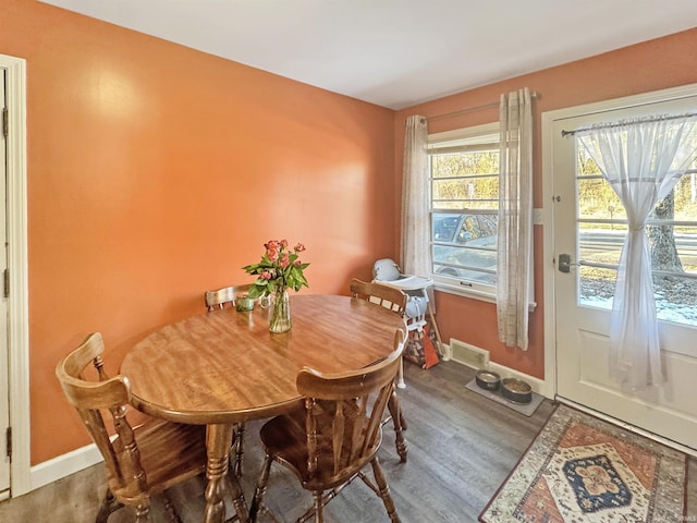 dining room with visible vents, baseboards, and wood finished floors