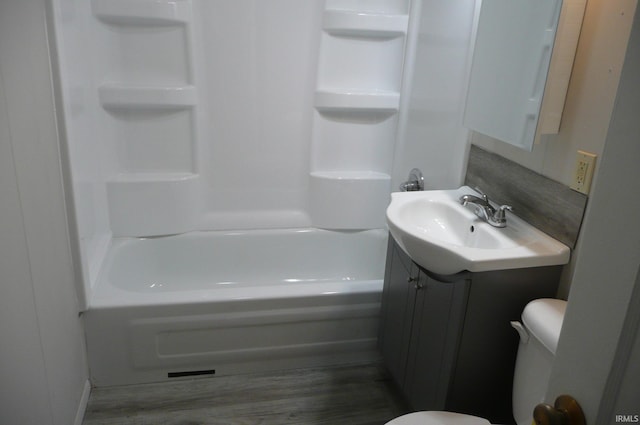 full bathroom featuring wood finished floors, vanity, toilet, and shower / bathing tub combination