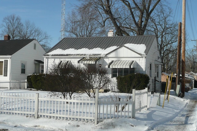 exterior space featuring a fenced front yard and a chimney