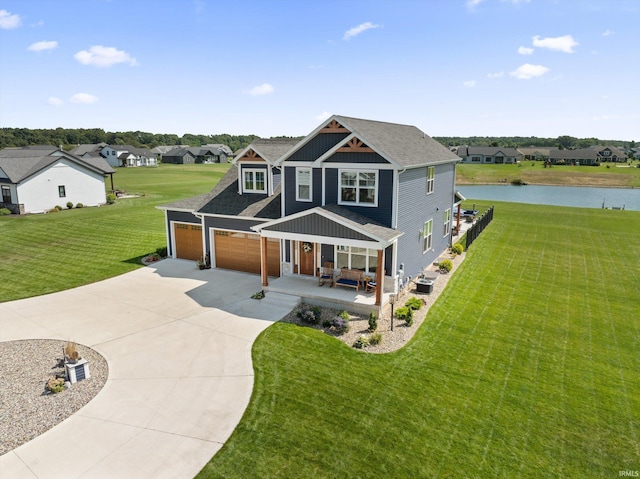 craftsman inspired home with an attached garage, covered porch, a water view, concrete driveway, and a front yard