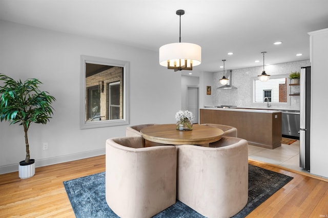 dining area featuring baseboards, recessed lighting, and light wood-style floors