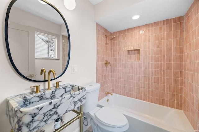 full bath featuring toilet, washtub / shower combination, and recessed lighting