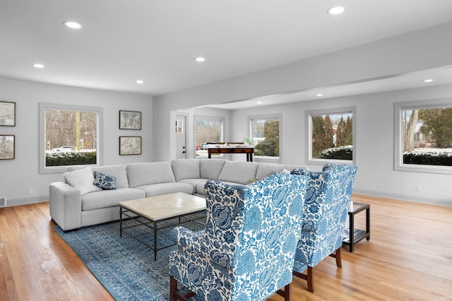 living area featuring recessed lighting, light wood-style flooring, and baseboards