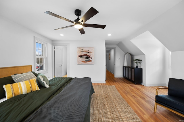 bedroom featuring baseboards, ceiling fan, light wood-style flooring, vaulted ceiling, and recessed lighting