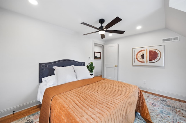 bedroom featuring baseboards, visible vents, wood finished floors, and recessed lighting