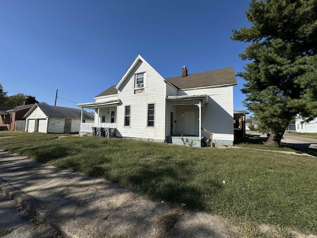 view of front facade with covered porch, a chimney, and a front lawn