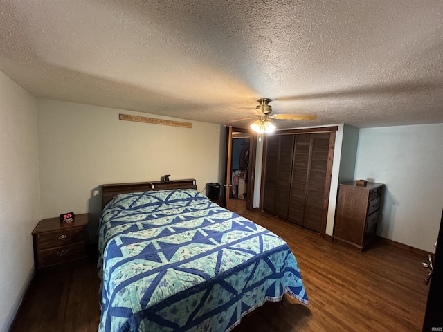 bedroom with a textured ceiling, dark wood-type flooring, a closet, and a ceiling fan