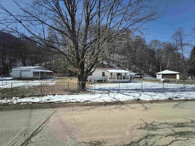 exterior space featuring an outbuilding, fence, and a detached garage