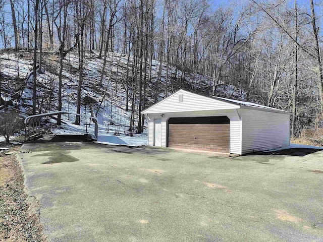 snow covered garage with a garage and a yard