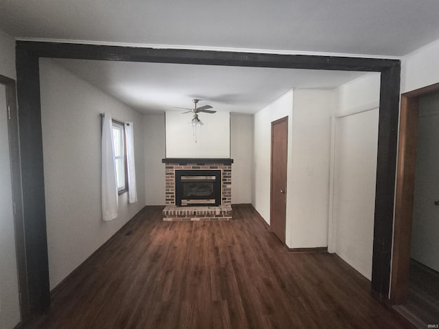 unfurnished living room featuring a ceiling fan, a fireplace, and dark wood-style floors