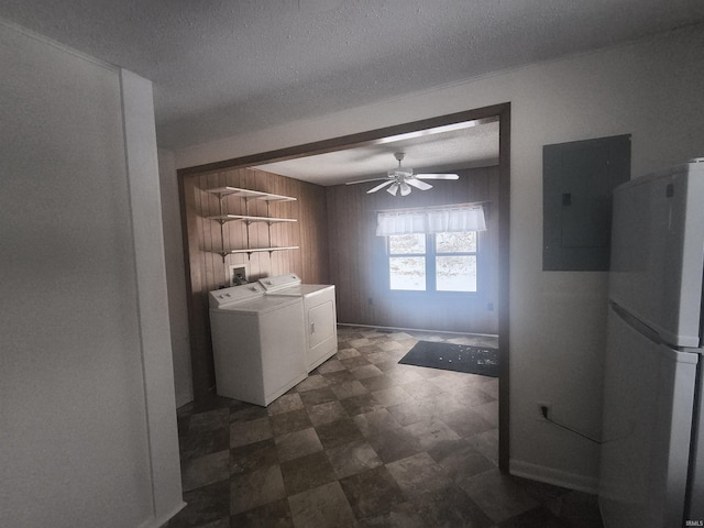 clothes washing area with ceiling fan, a textured ceiling, washing machine and dryer, laundry area, and electric panel