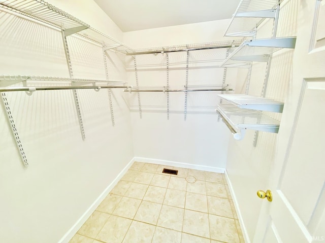 walk in closet with light tile patterned flooring and visible vents