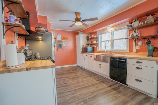 kitchen featuring butcher block countertops, white cabinetry, black dishwasher, open shelves, and light wood finished floors