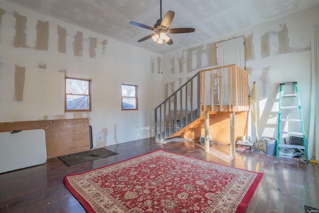 interior space featuring dark wood-style floors, stairway, and a ceiling fan