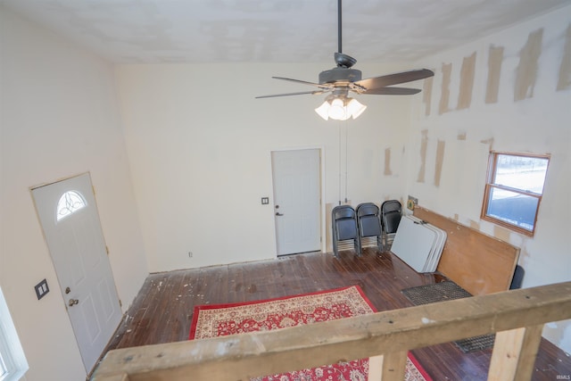 foyer featuring dark wood-style floors, a high ceiling, and a ceiling fan