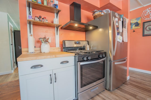 kitchen featuring open shelves, wooden counters, white cabinets, gas range, and extractor fan