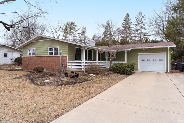 single story home with concrete driveway, brick siding, and an attached garage