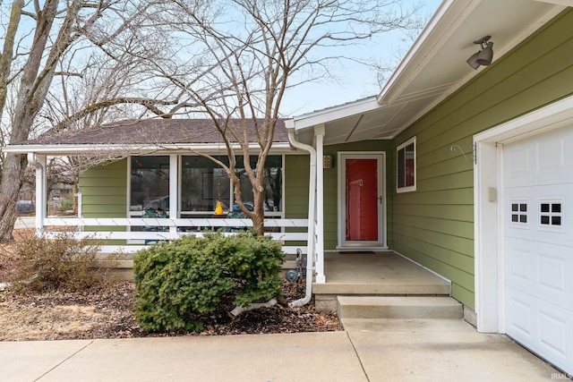 doorway to property with a garage