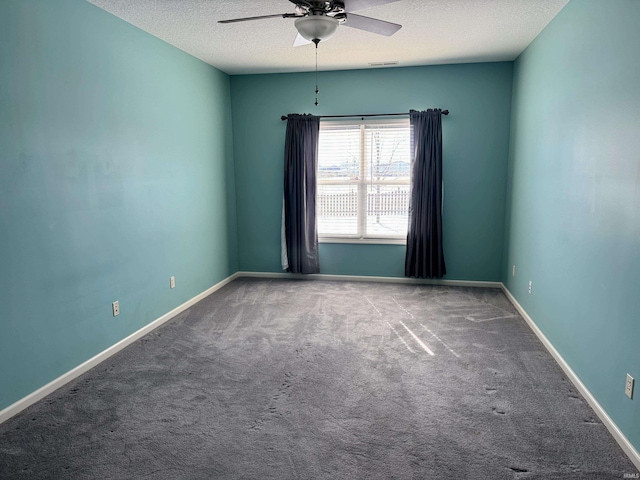 unfurnished room featuring a textured ceiling, carpet flooring, a ceiling fan, and baseboards