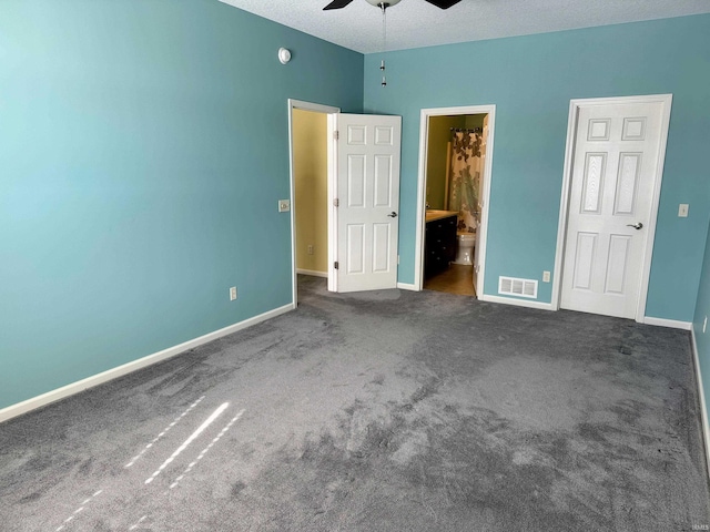 unfurnished bedroom with carpet flooring, visible vents, a textured ceiling, and baseboards