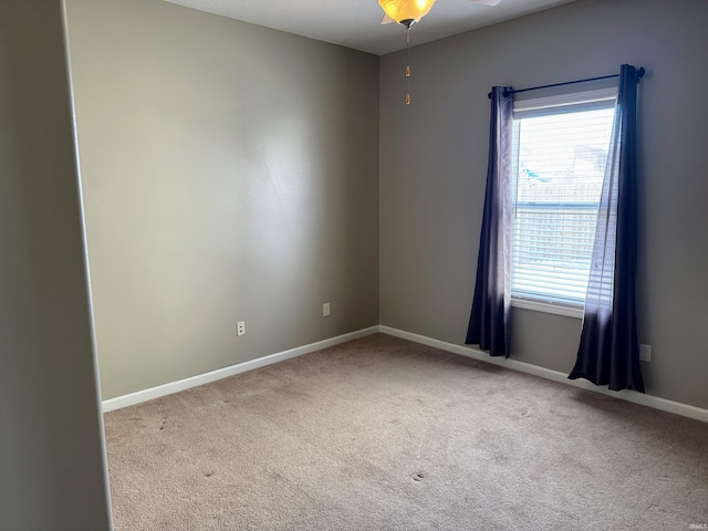 unfurnished room featuring carpet flooring and baseboards