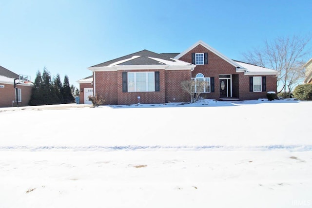 view of front of home featuring a garage and brick siding