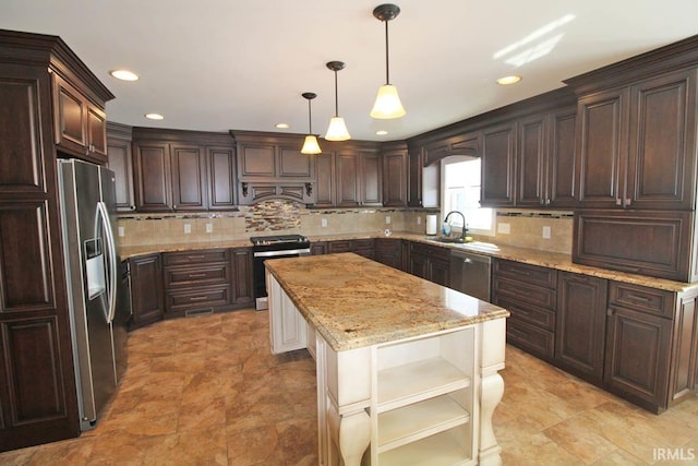 kitchen with a sink, hanging light fixtures, appliances with stainless steel finishes, a center island, and open shelves