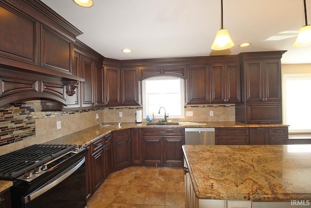 kitchen with range with gas stovetop, hanging light fixtures, light stone countertops, stainless steel dishwasher, and a sink